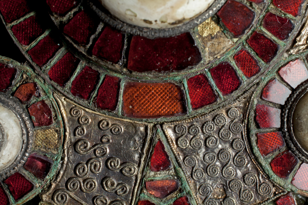 Photo of the garnet inlaid cloisonné composite disc brooch. 